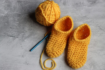 Crocheted slippers made of organic yarn. Soft and comfortable hand crafted footwear. Handmade Christmas gifts ideas. 