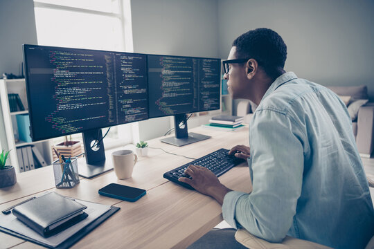 Side photo of focused concentrated serious programmer guy researching code mistakes errors debug fixing looking for solution in office