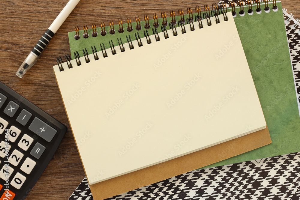 Poster top view of a pen and notepad on a wooden table background. minimal style business desk concept with