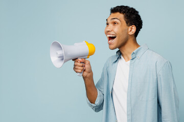 Side view young surpised man of African American ethnicity in shirt casual clothes hold in hand...