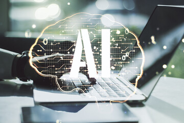Creative artificial Intelligence concept with human brain hologram and hands typing on laptop on background. Multiexposure