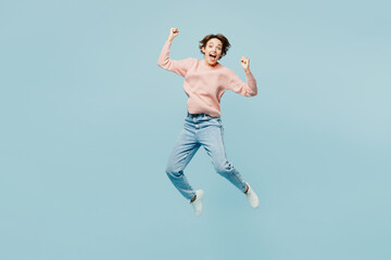 Full body young overjoyed excited woman she wears beige knitted sweater casual clothes jump high do...