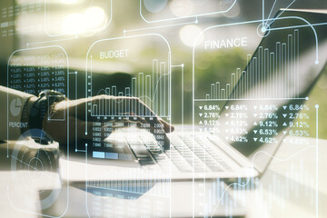 Multi exposure of creative statistics data hologram with hands typing on computer keyboard on background, stats and analytics concept
