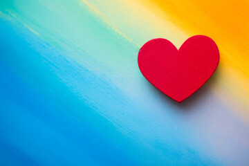 Multicolored heart against a vivid canvas.