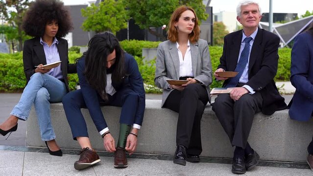 Multiracial business people eating fresh poke food during lunch break outside of office - 
