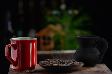 Red cup and coffee beans with selective focus
