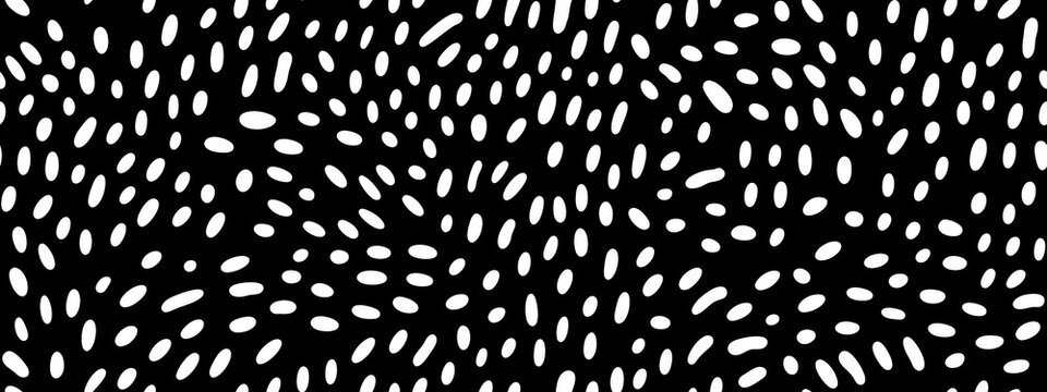 Seamless small dense polkadot animal spots pattern in white on black background. Abstract aboriginal dot art motif or organic cellular texture in a trendy doodle line art or linocut style
