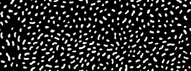 Seamless small dense polkadot animal spots pattern in white on black background. Abstract aboriginal dot art motif or organic cellular texture in a trendy doodle line art or linocut style - obrazy, fototapety, plakaty