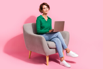 Full length photo of young programmer girl using digital computer browsing internet and analyzing...