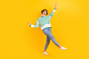 Fototapeta na wymiar Full body photo of attractive careless girl wear casual stylish striped pullover with jeans party event isolated on yellow color background