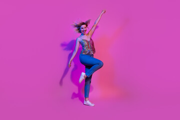 Fototapeta na wymiar Full length photo of positive cheerful lady bachelorette dancing with raising hands at nightclub isolated vivid neon color background