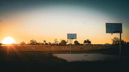 Sunset over basketball court in Arizona field © Trenton