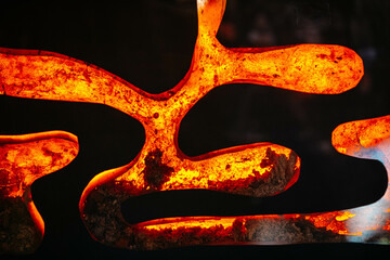 Shapes of molten metal on black background