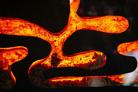 Shapes of molten metal on black background