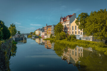 Fototapeta na wymiar Tenement houses on the Młynowka canal in Opole, Poland.