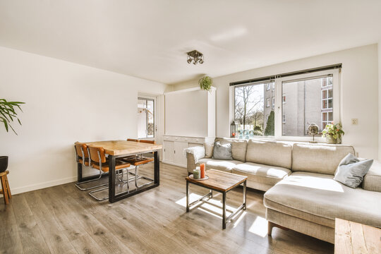 Living room with dining table and sofa by window