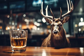 Gordijnen Drinking deer with alcohol in a pub. © vlntn