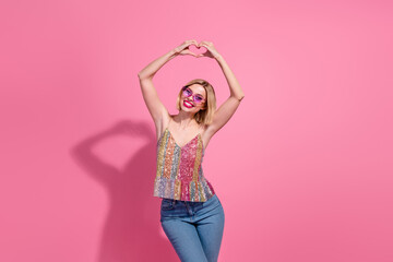 Photo of young positive girl blonde hair blonde hair show fingers heart symbol lovely discotheque party isolated on pink color background