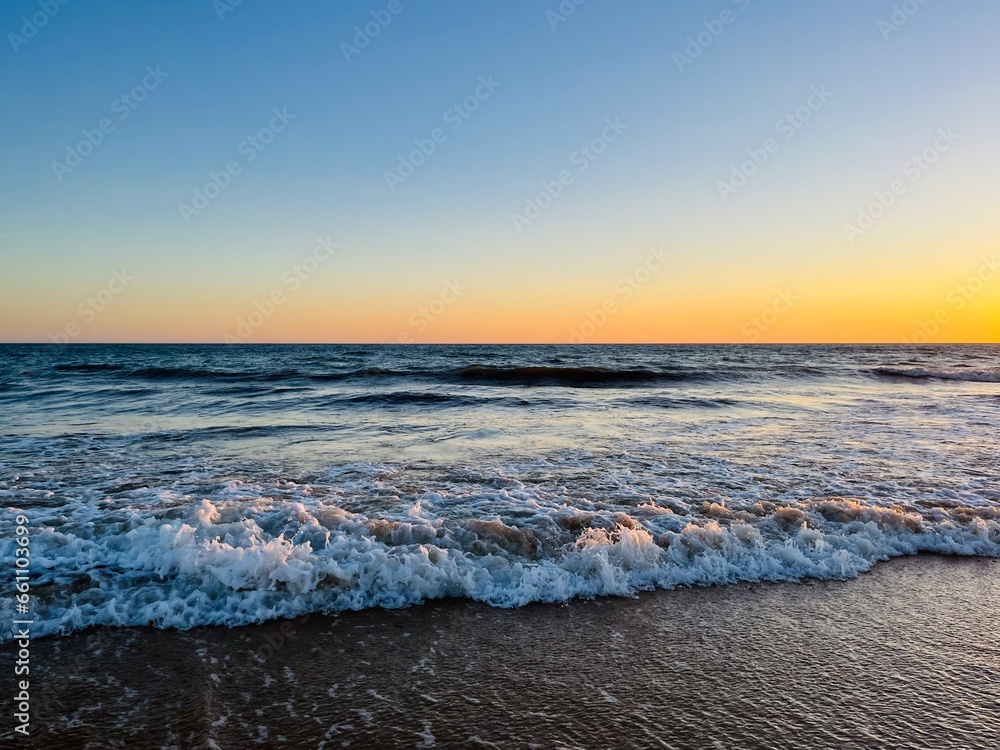 Wall mural Quiet orange sea horizon, evening seascape background