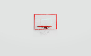 Basketball red metal hoop and backboard fixed on white concrete wall front view