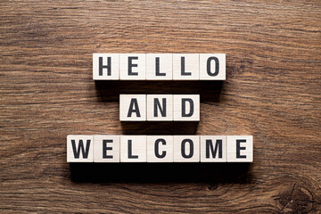 Hello and welcome - word concept on building blocks, text - obrazy, fototapety, plakaty