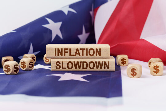 On the US flag and wooden plates with the inscription - inflation slowdown