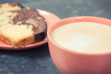Cup of cappuccino and fresh baked yeast dough with cocoa. Delicious dessert