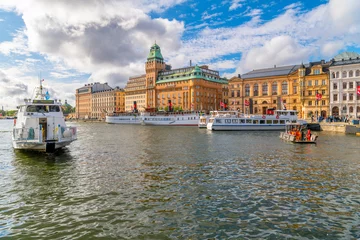 Zelfklevend Fotobehang Stockholm Tourism cruise boats and water tours leave the docks at Nybroviken Bay, or New Bridge Bay in central Stockholm, Sweden.