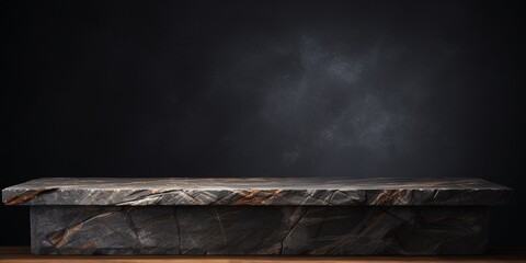 Black stone table top isolated on black background, rough rock display podium on dark black backdrops.