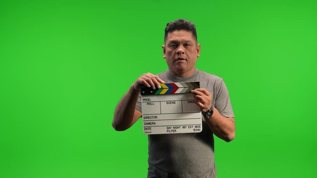 Asian man holding up movie slate