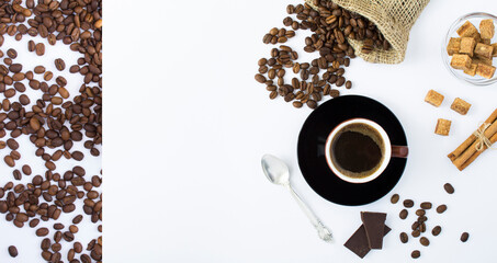 Black coffee in the brown cup and roasted coffee bean on the white background. Top view. Copy space.