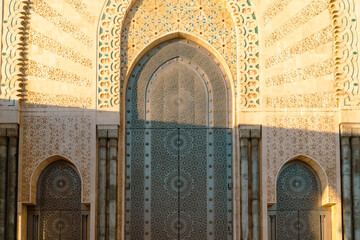 Moroccan mosaic and patterns , view of Hassan II Mosque big gate, Detail of Hassan II Mosque at sunset in Casablanca, Morocco