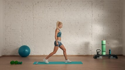 Healthcare and wellness advertisement concept. Athletic woman fitness coach doing explaining lunges for online classes.