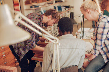 Young and diverse group of architects working on a project together in a startup company office