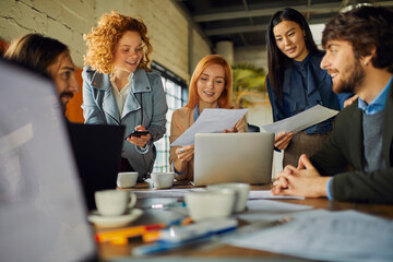 Young and diverse group of designers having a meeting in an office while working in a startup company