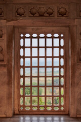 Decorative mesh window in Agra Red Fort, beautiful ancient windows with beautiful wall decorations, ancient window with old indian handmade ornament decoration in Agra Red Fort landmark building