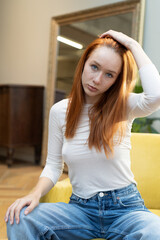 portrait of a young beautiful woman with red hair in  studio