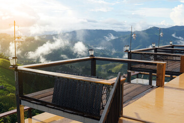 A steel balcony extends from the front of the room for viewing the high mountain peaks and mist...