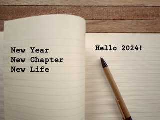 New Year motivational concept. New Year, New Chapter, New Life and Hello 2024 written on a book. With blurred styled background.