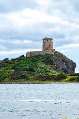 Fototapeta na wymiar lighthouse on the shore of the island, Sardinia, Italy