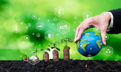 Stack of money growing with businessman investing in eco-friendly technology symbolize green...