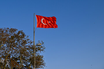 Turkish flag against blue sky   