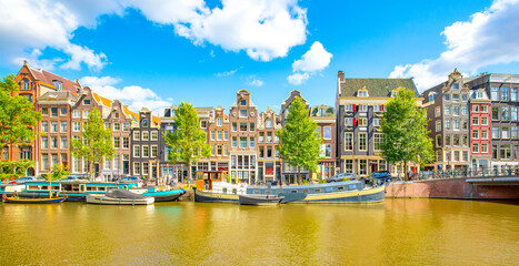 Amsterdam city skyline, colorful dancing houses over Singel canal, Netherlands