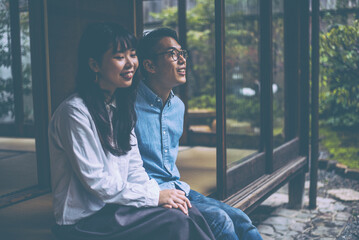 Young japanese couple spending time in their house - obrazy, fototapety, plakaty