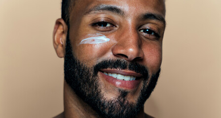 Fototapeta premium Image of a young man taking care of his skin