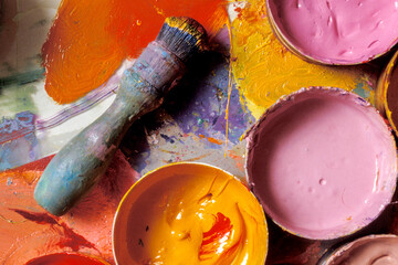 artists brushes and color palette paint cups