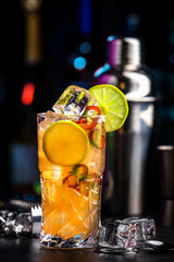 Siam sunrise trendy cocktail drink with vodka, coconut liqueur, ginger, chili pepper, soda, lime...