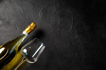 Glass of wine with glass on dark background