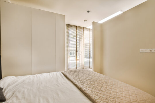 Bedroom with bed and wardrobe by window