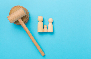 Wooden family figures with judge's gavel on color background,top view